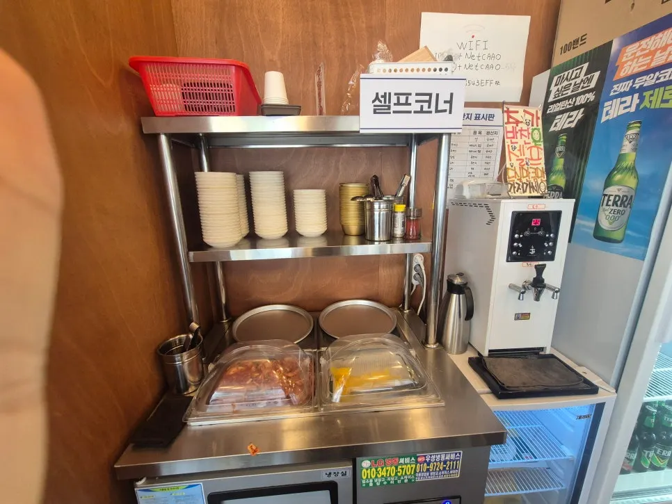 Self-service corner with kimchi, pickled radish, and broth