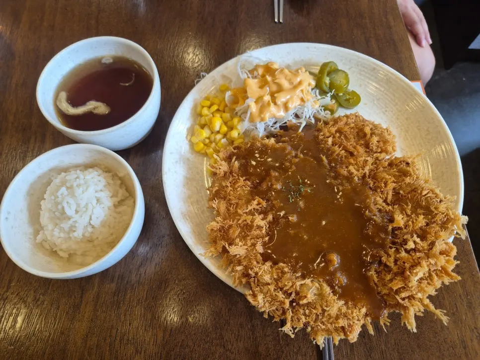 Cross-section of the pork cutlet drizzled with sauce