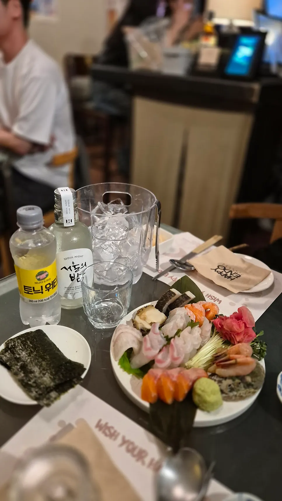 Closing spread of sashimi and drink glasses on the table