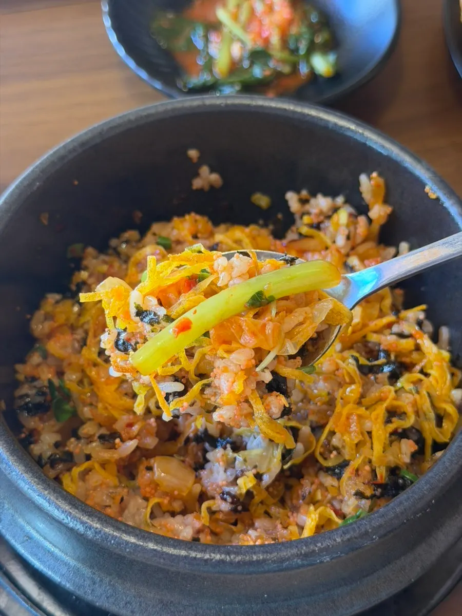 A bowl of albap mixed with chopsticks