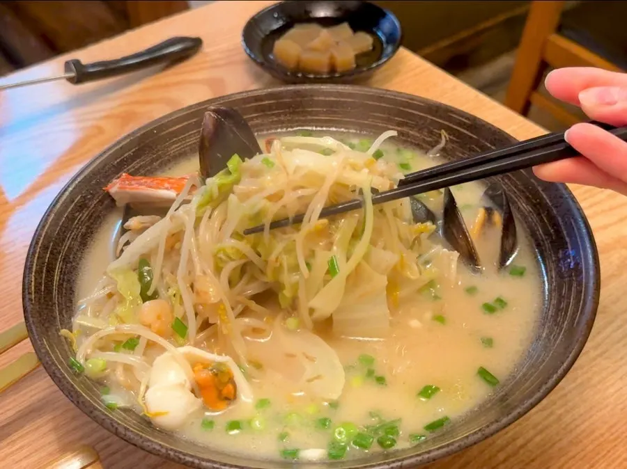 Jjamppong tang broth filled with bean sprouts and seafood