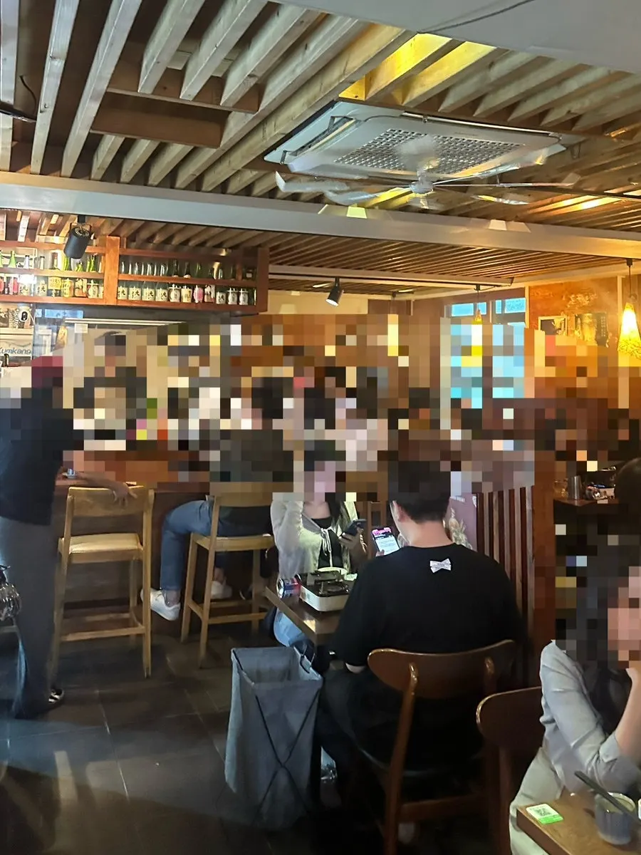 Dachi counter seats with a view of yakitori being grilled