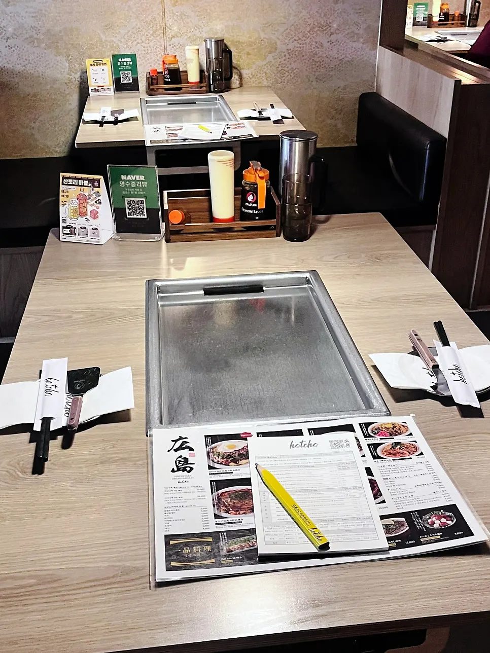 Pork being added to Hiroshima-style okonomiyaki during cooking