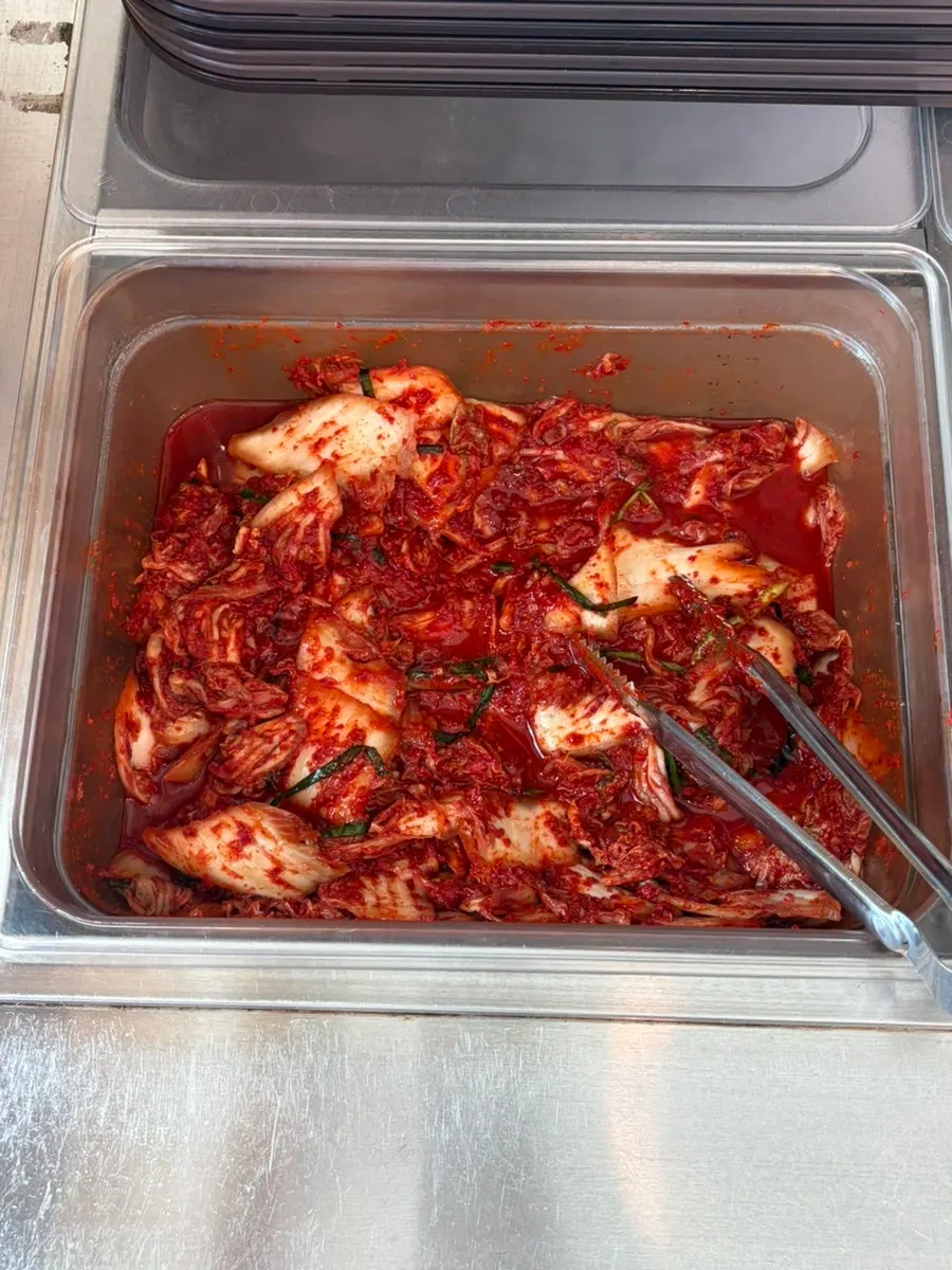 Side dish containers and tongs at the self-serve bar