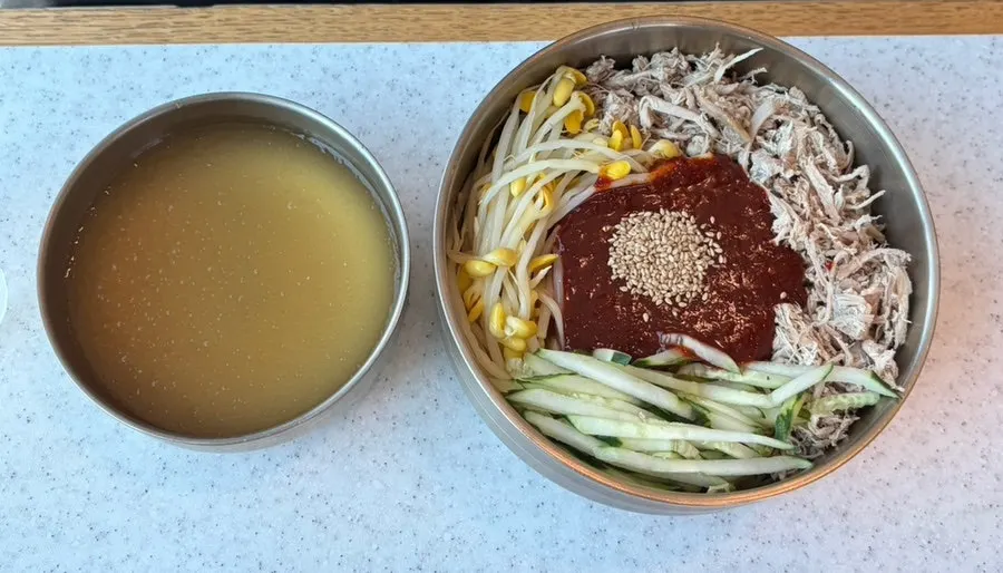 Close-up of the pork noodle soup's noodles and meat topping
