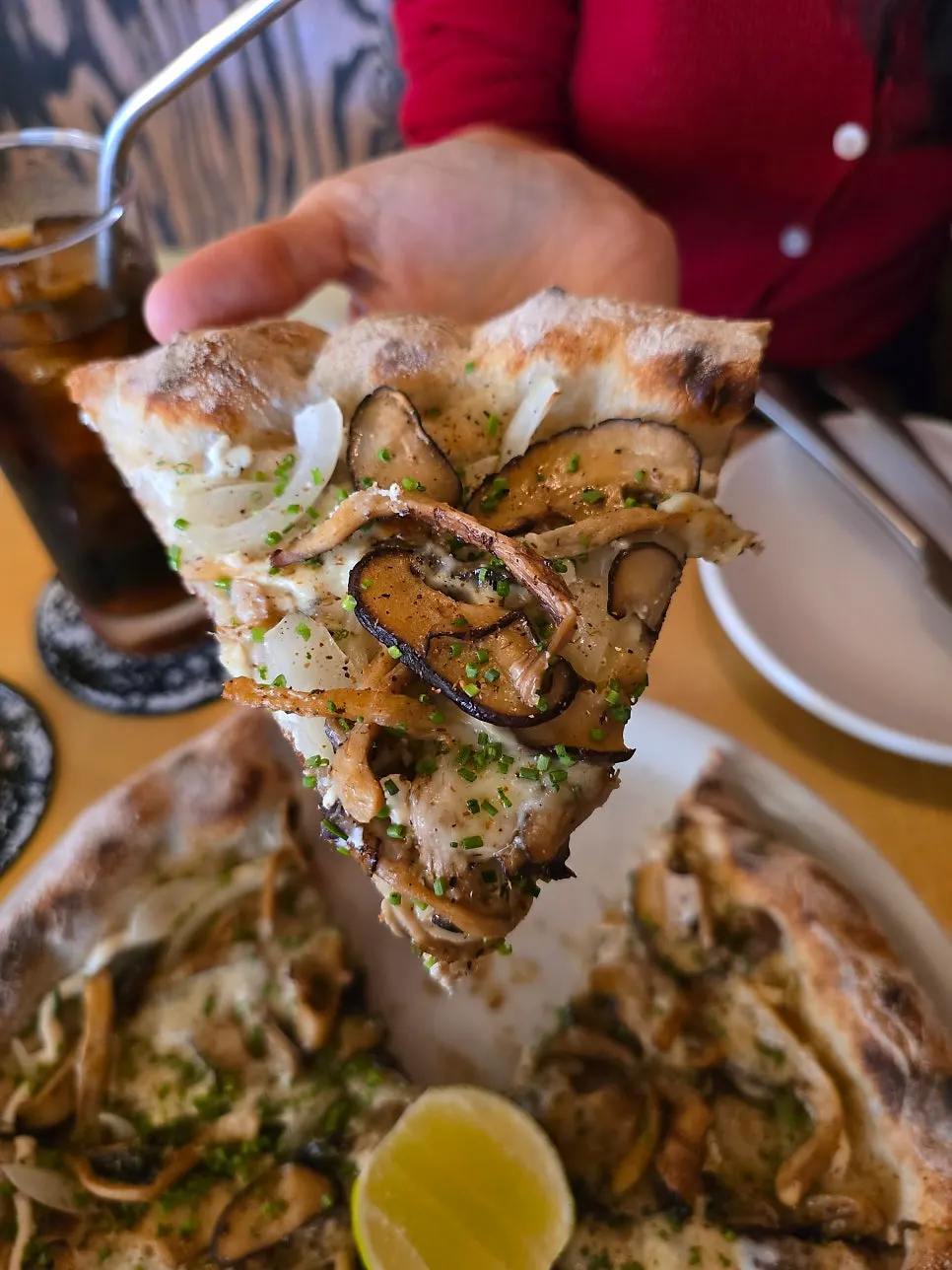 A slice of pizza picked up by hand