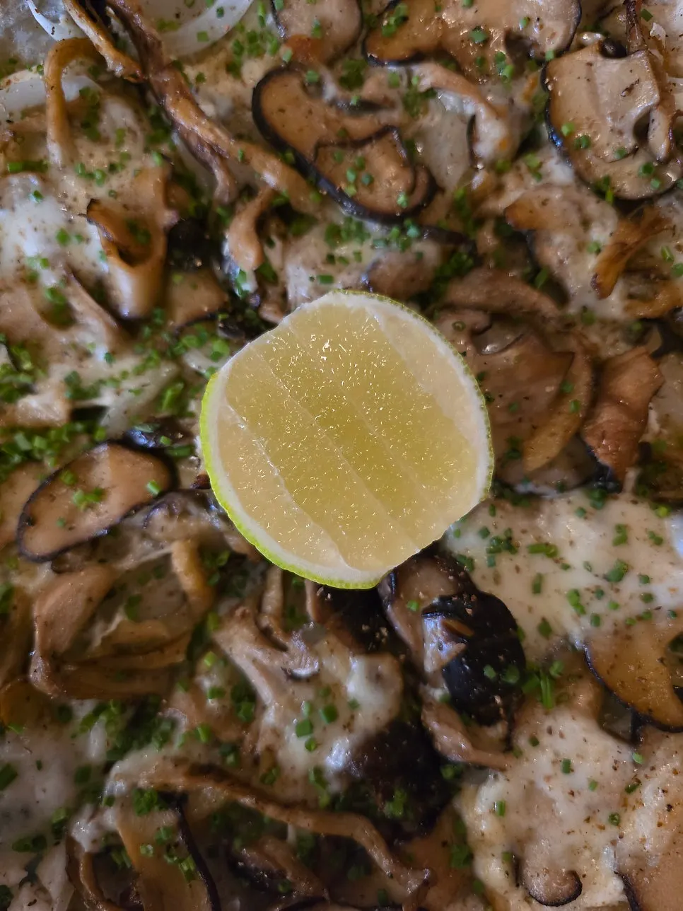 A wedge of lime served with the pizza