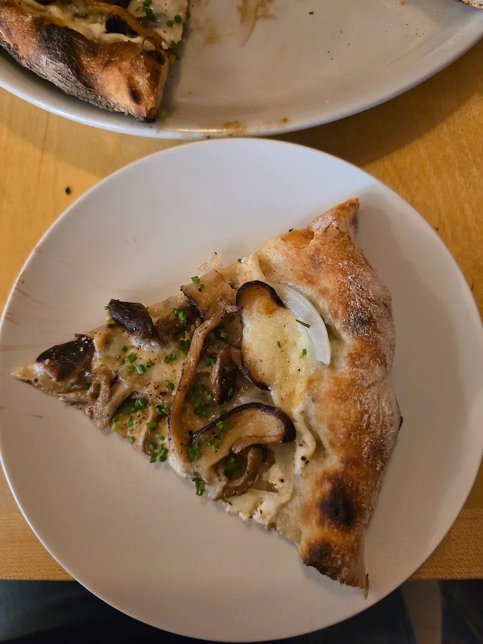 Fall mushroom and smoked mozzarella pizza with lime squeezed on top