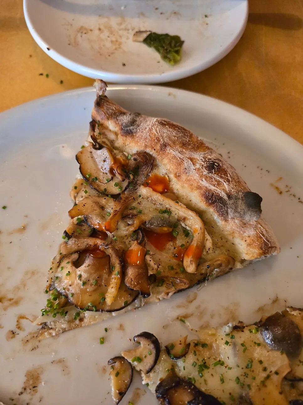Pizza slice with RED Tabasco drizzled on top