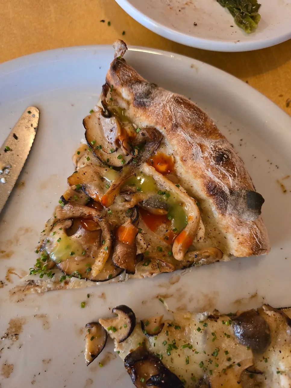 Pizza slice with GREEN Tabasco added on top