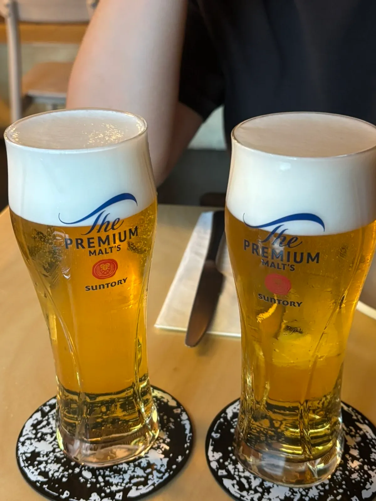 Fall mushroom wood-fired pizza served alongside beer