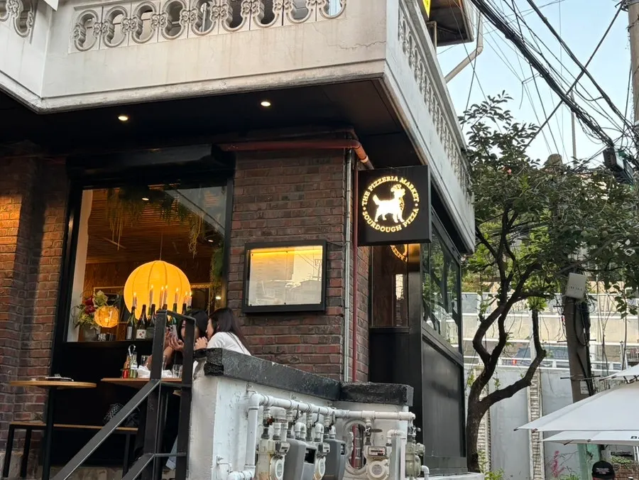 Nighttime Haebangchon street and the pizza restaurant's atmosphere