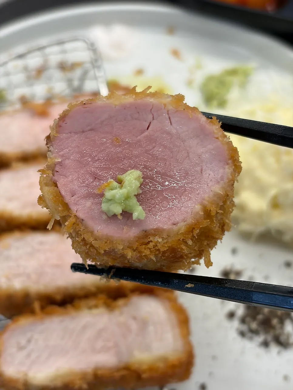 A piece of katsu drizzled with truffle oil