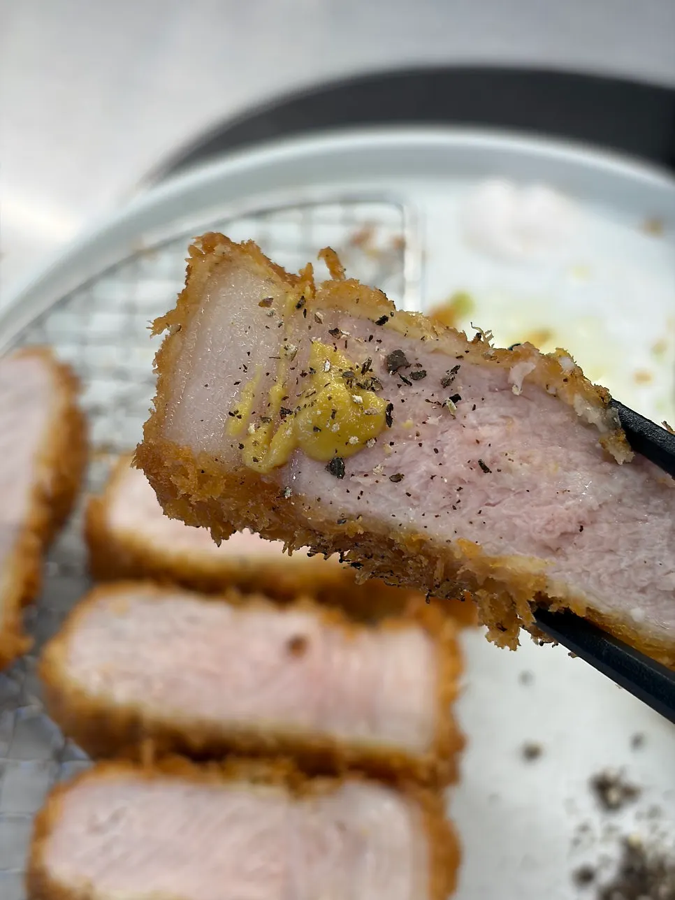 A cross-section of katsu dipped in sauce