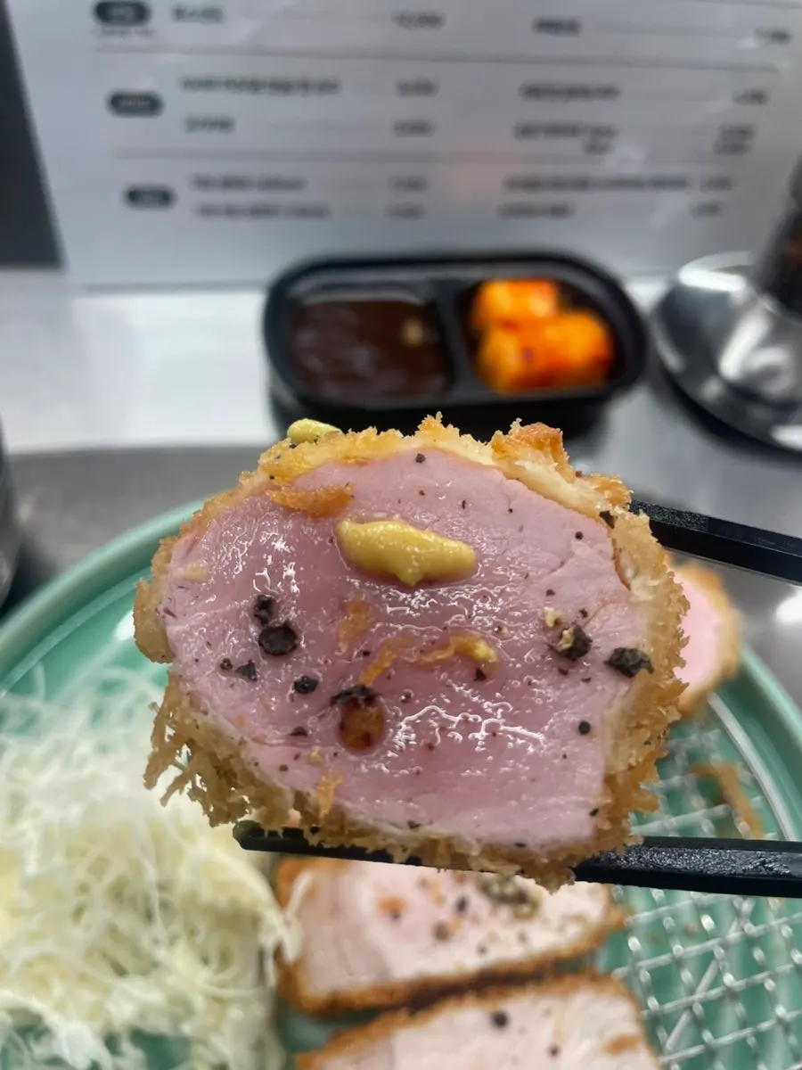 A piece of tenderloin katsu served with mustard