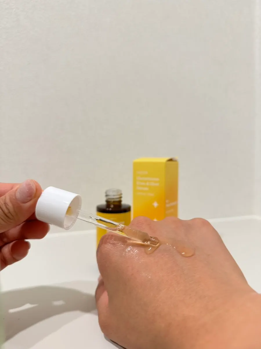 Yellow-tinted serum texture dabbed on the back of the hand
