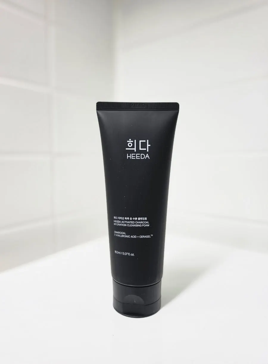 Holding the HEEDA Cleansing Foam tube