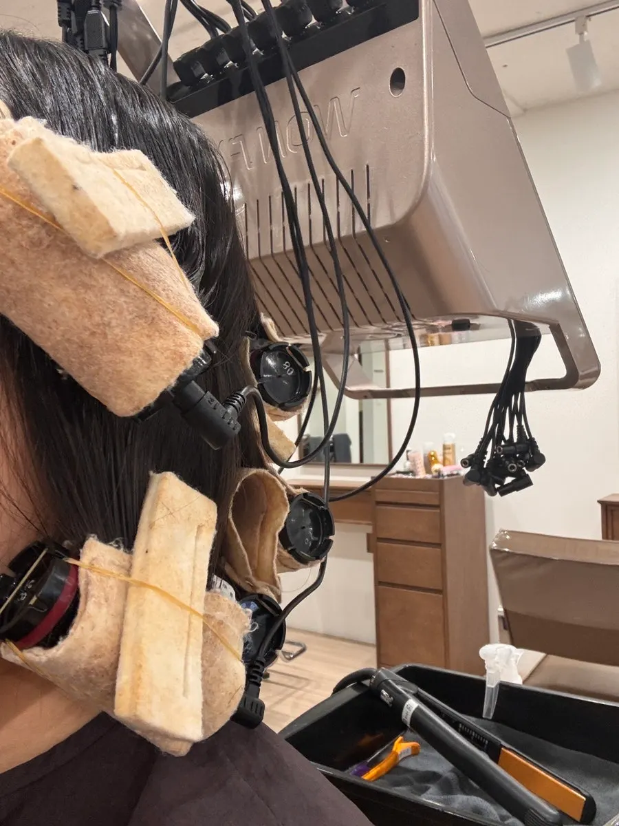 Medium-length hair wound onto C-curl perm rods