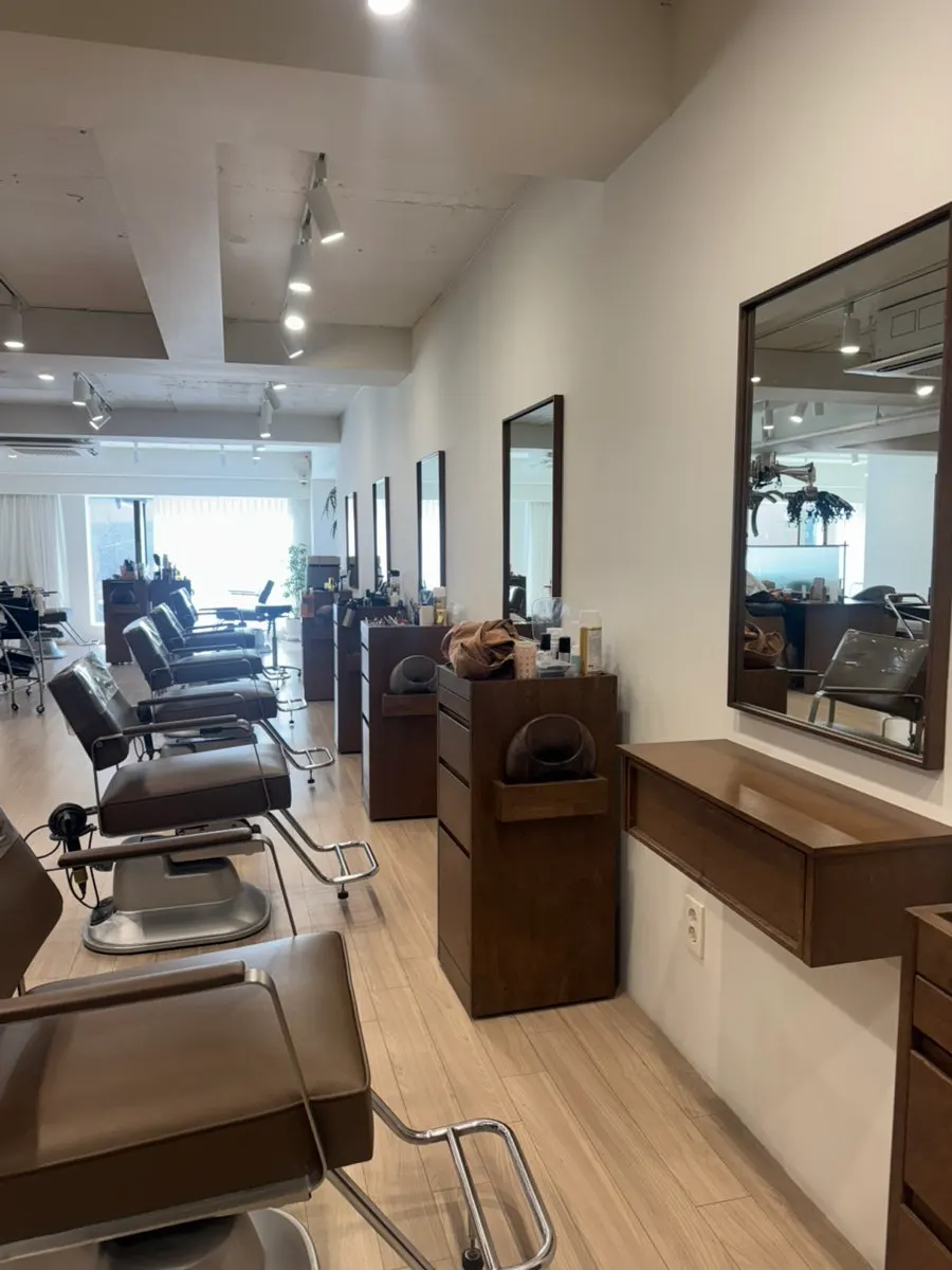 Salon treatment chair lit by natural light through full-height windows