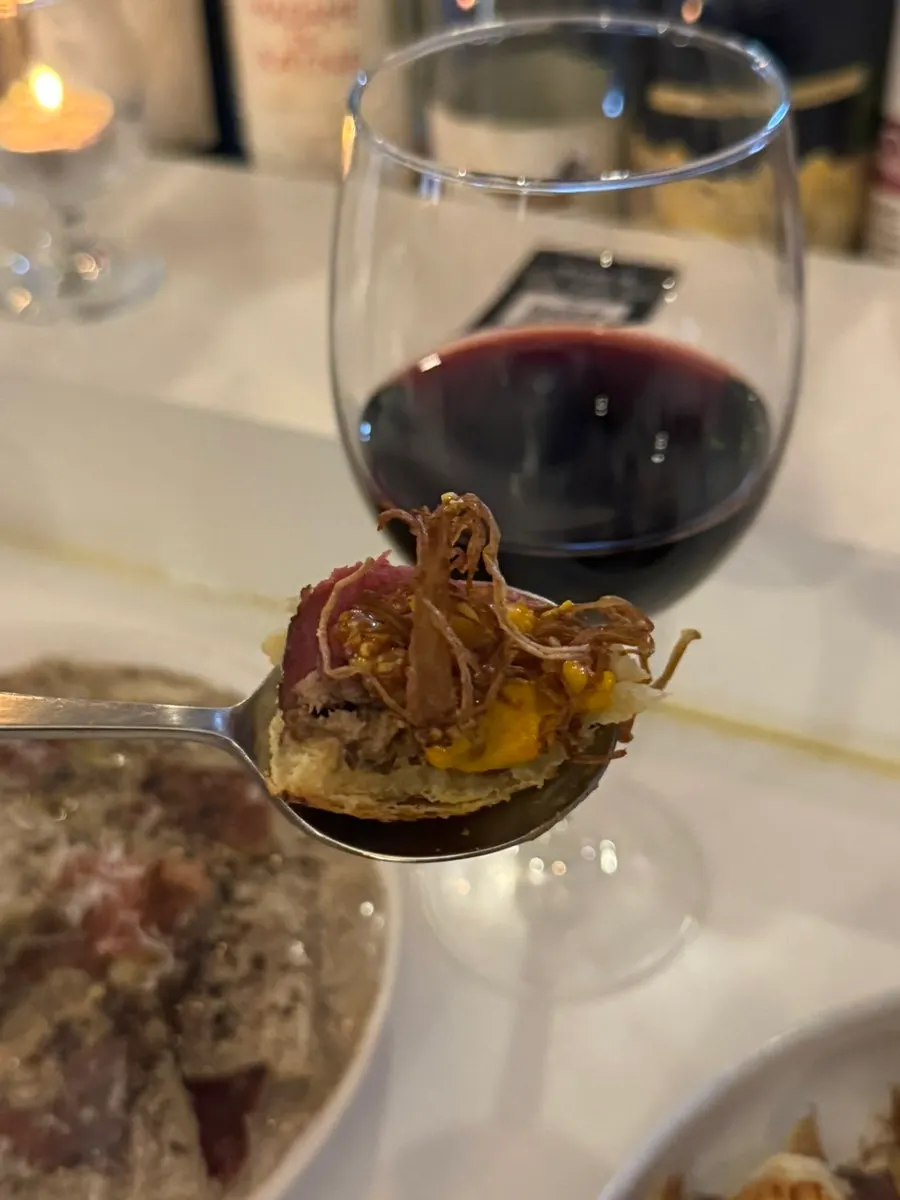 A glass of wine served alongside the meal