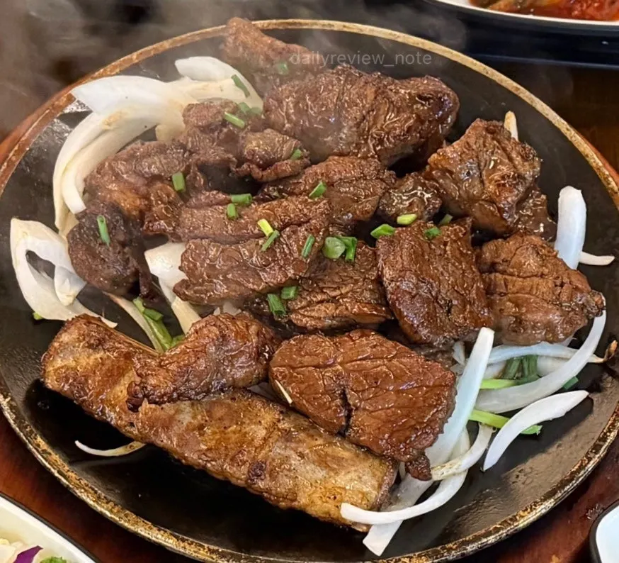 Marinated short rib on an iron plate laid with vegetables