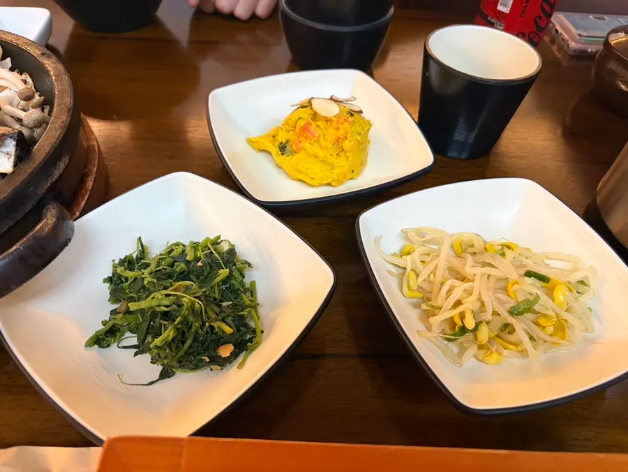 Lid lifted off the hot pot rice revealing a large piece of geumtae