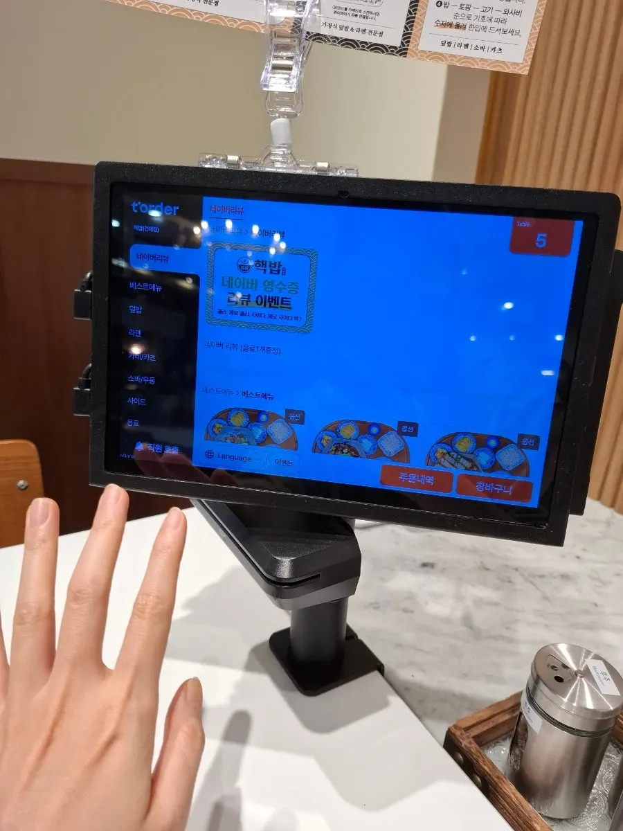 Food photos displayed on the wall as menu guides