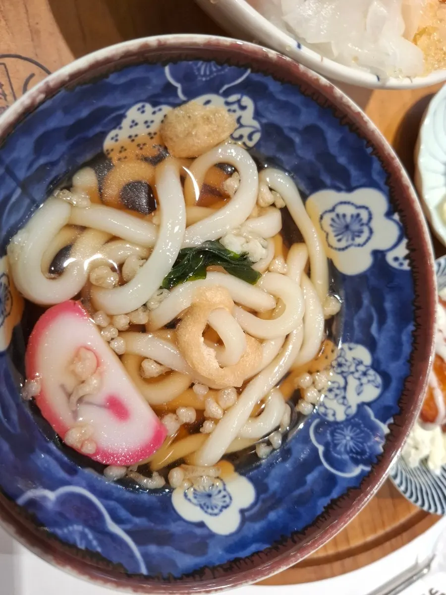 Rice bowl topped with thick salmon sashimi, flying fish roe, and egg yolk