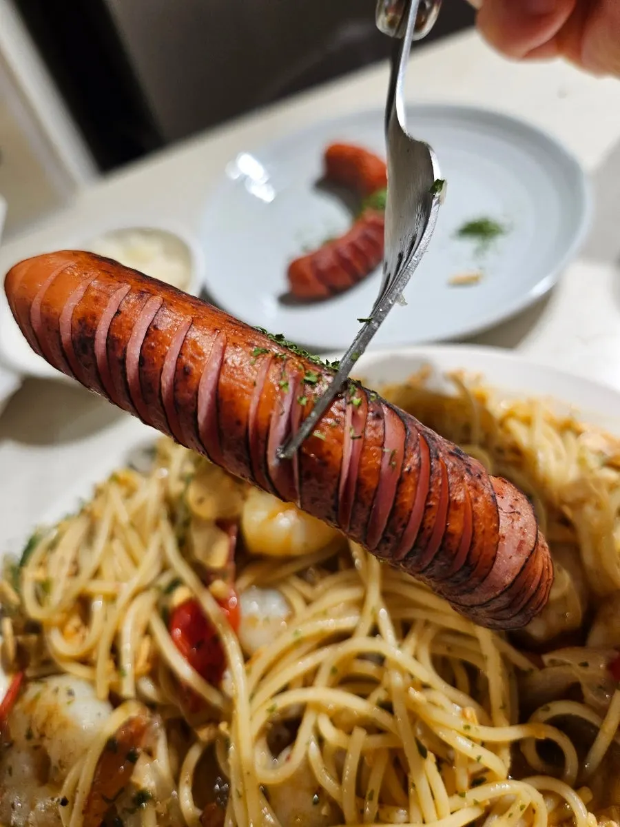 Close-up of the oil pasta topped with large shrimp
