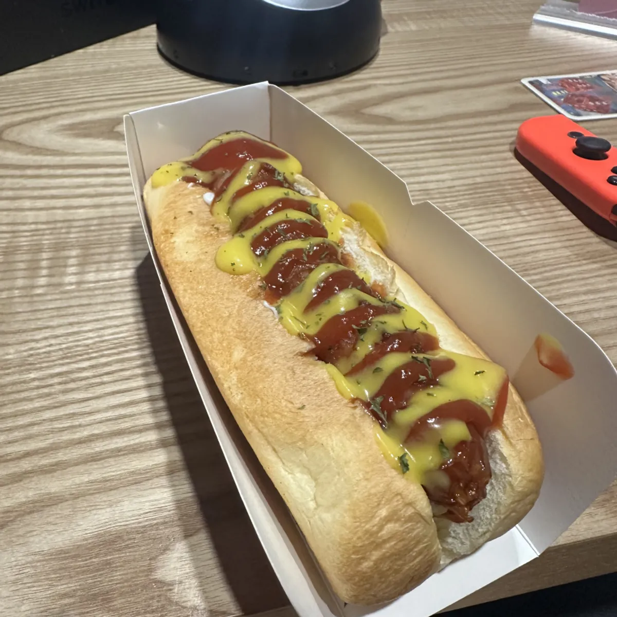 Food menu board listing tteokbokki, ramyeon, corn dogs, and more