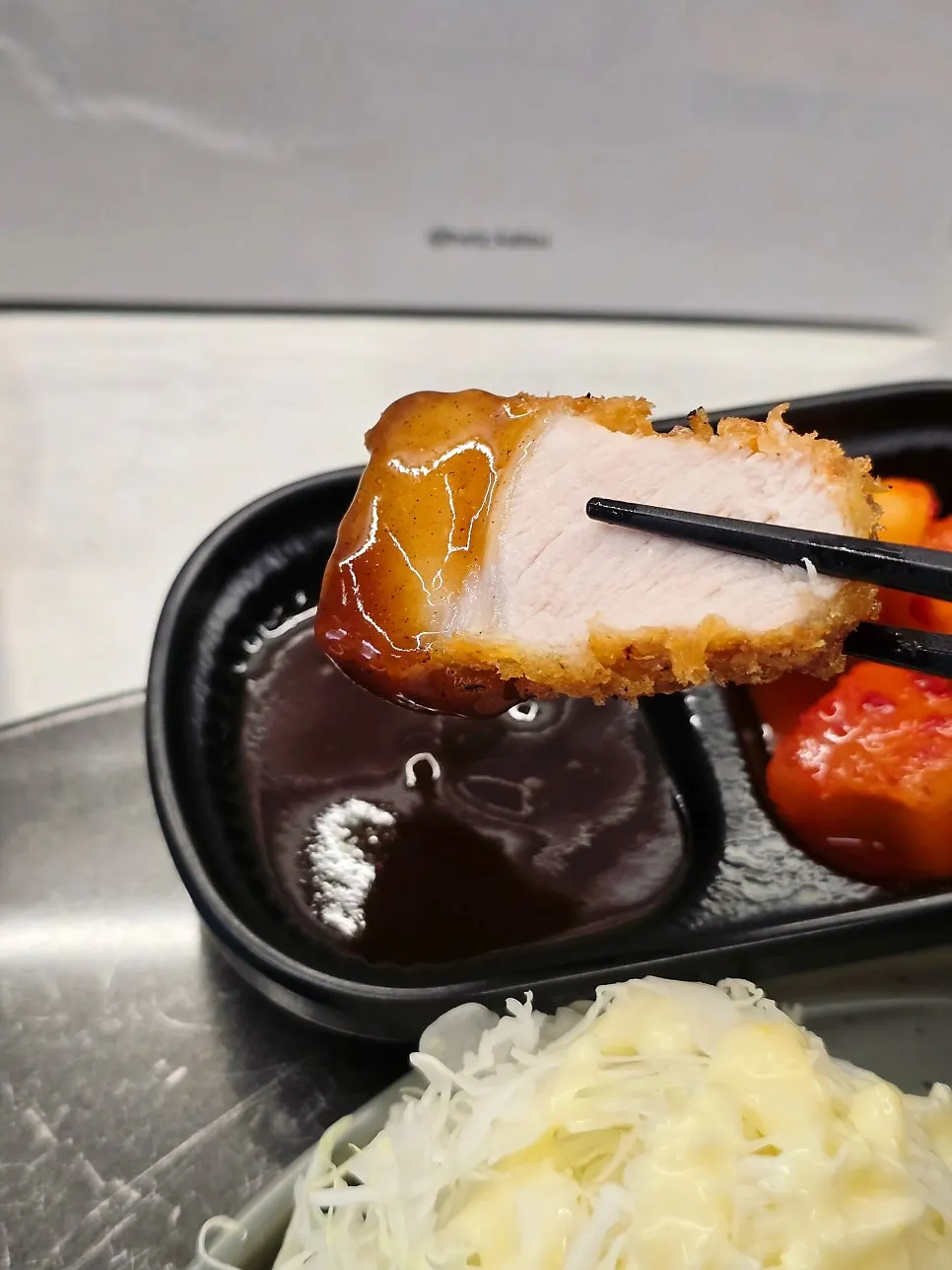 Picking up a piece of black pork tonkatsu