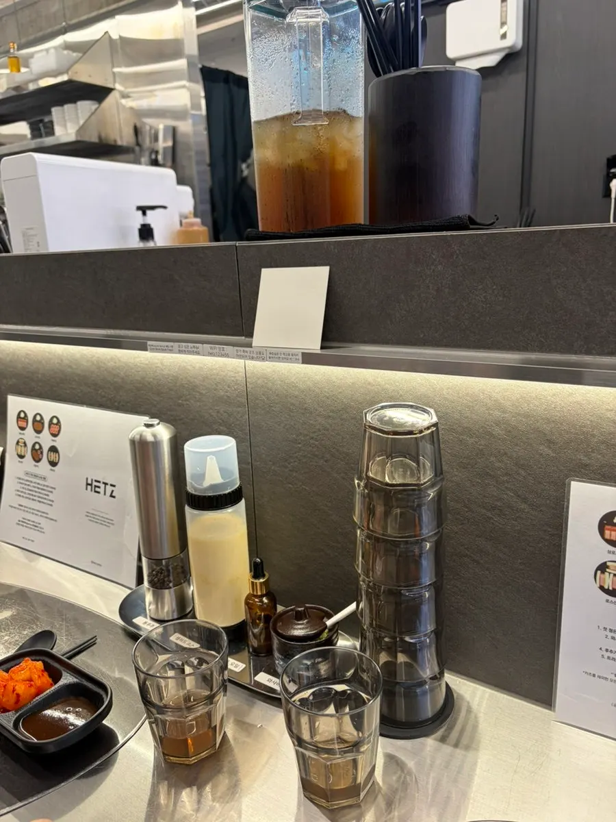 Bar-seat setup with black pepper, truffle oil, and wasabi