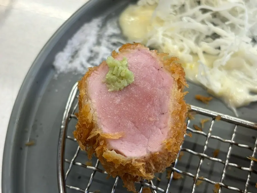 Loin katsu topped with black pepper and truffle oil