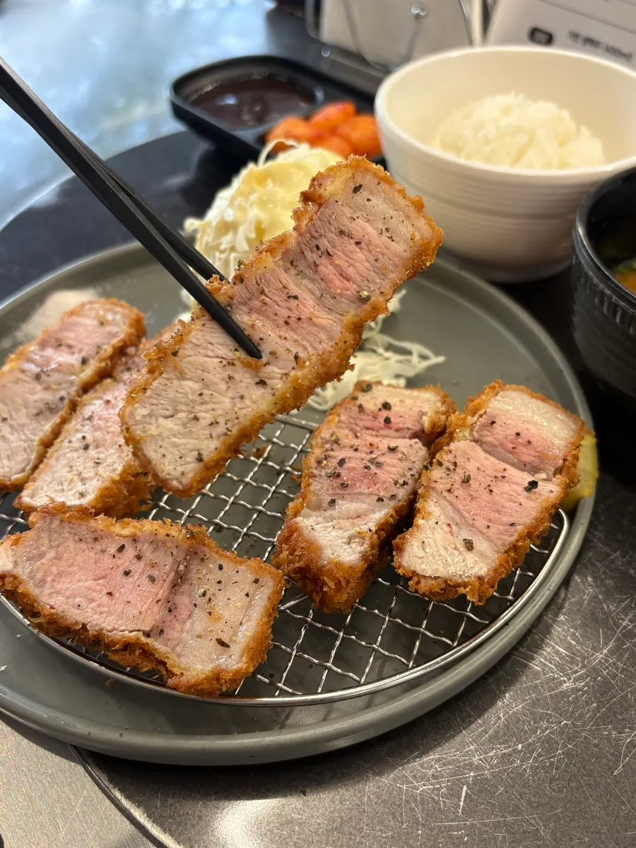 A piece of tonkatsu paired with silbi kimchi