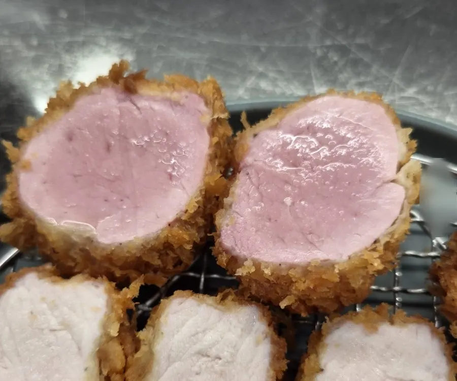 Cross-section of tenderloin katsu with a slight sheen of fat