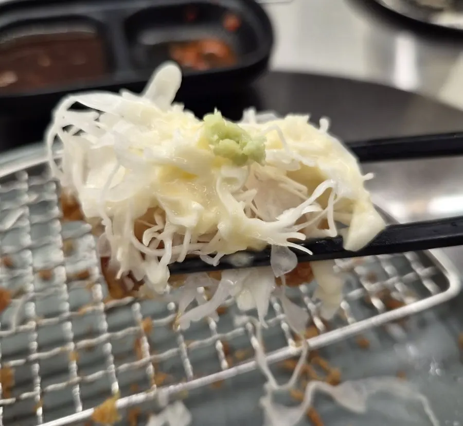A piece of tonkatsu eaten topped with salad