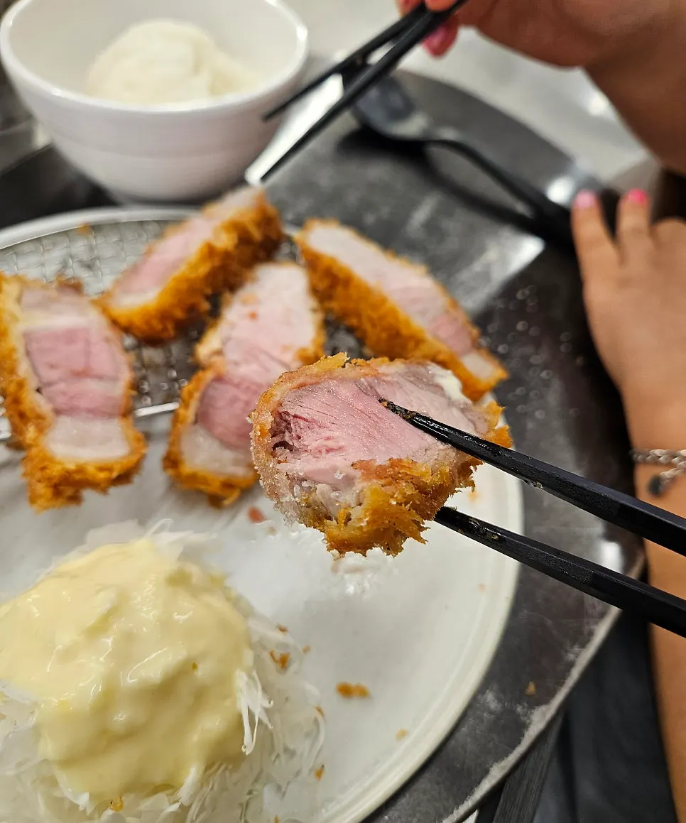 Cross-section of thickly sliced Jeju black pork sang loin katsu