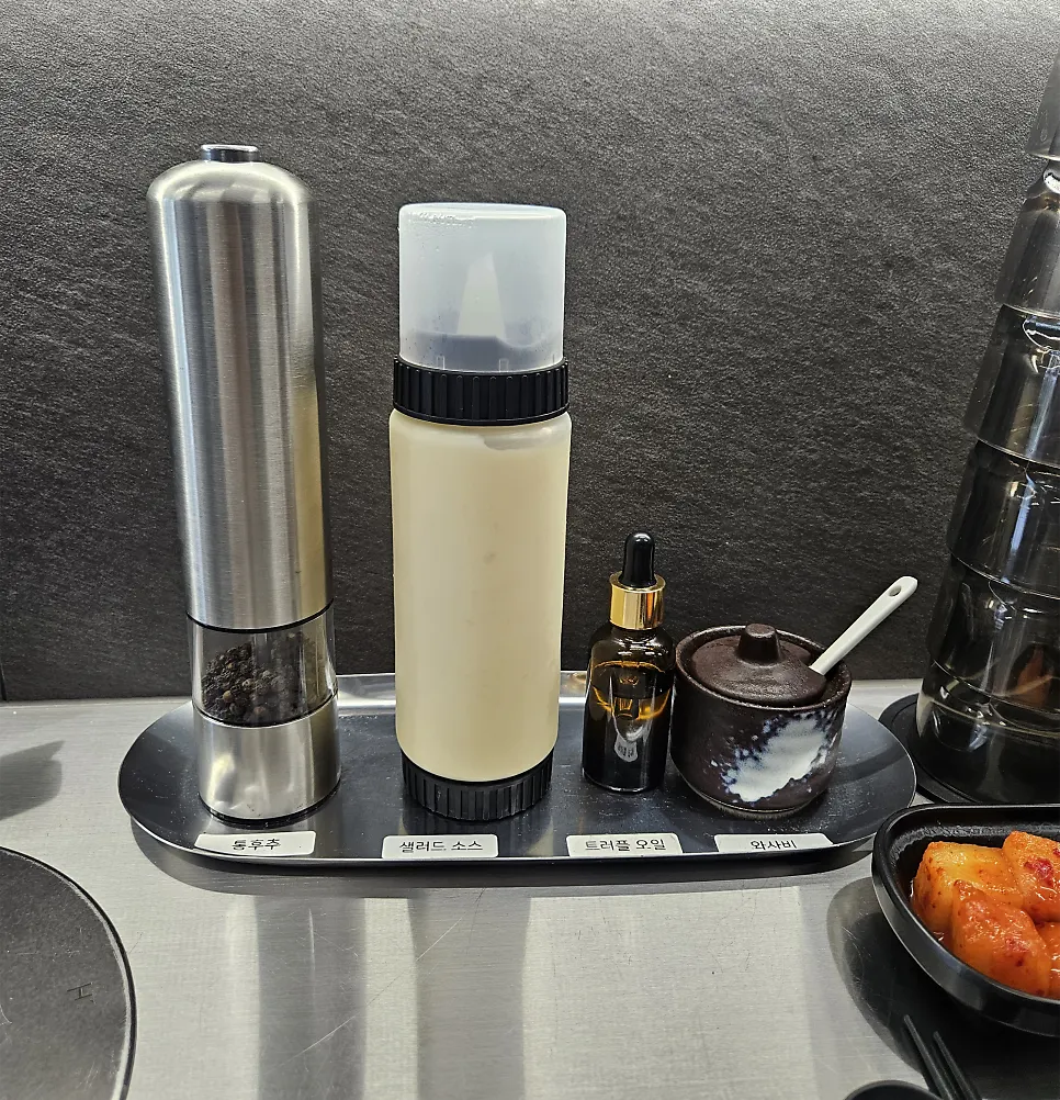 Salt, wasabi, and truffle oil sides prepared on the table