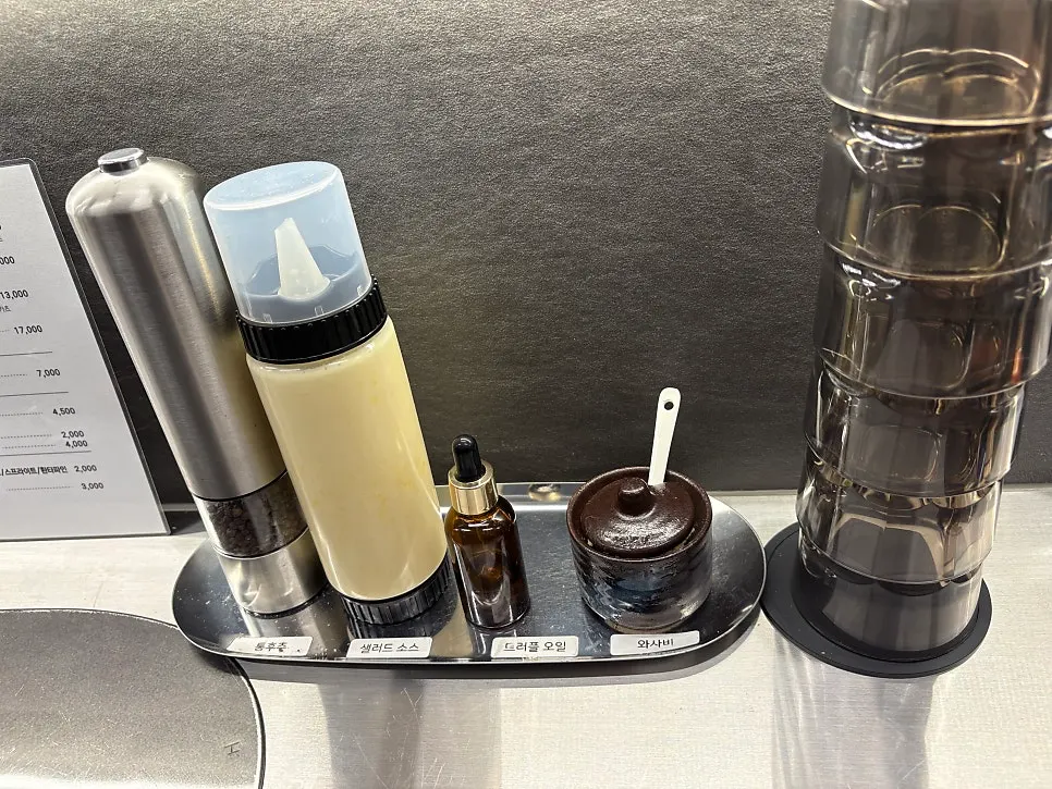 Table setting with utensils, salt, and sauce