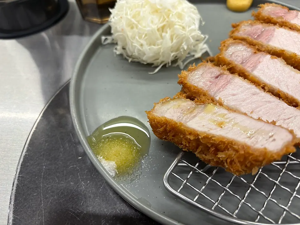 Cross-section of a piece of black pork loin katsu