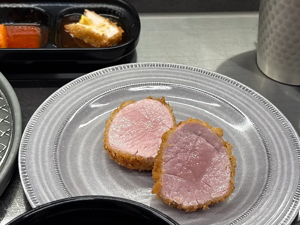 A piece of tonkatsu topped with mustard