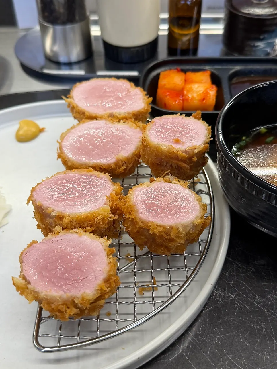 A piece of tonkatsu topped with truffle oil