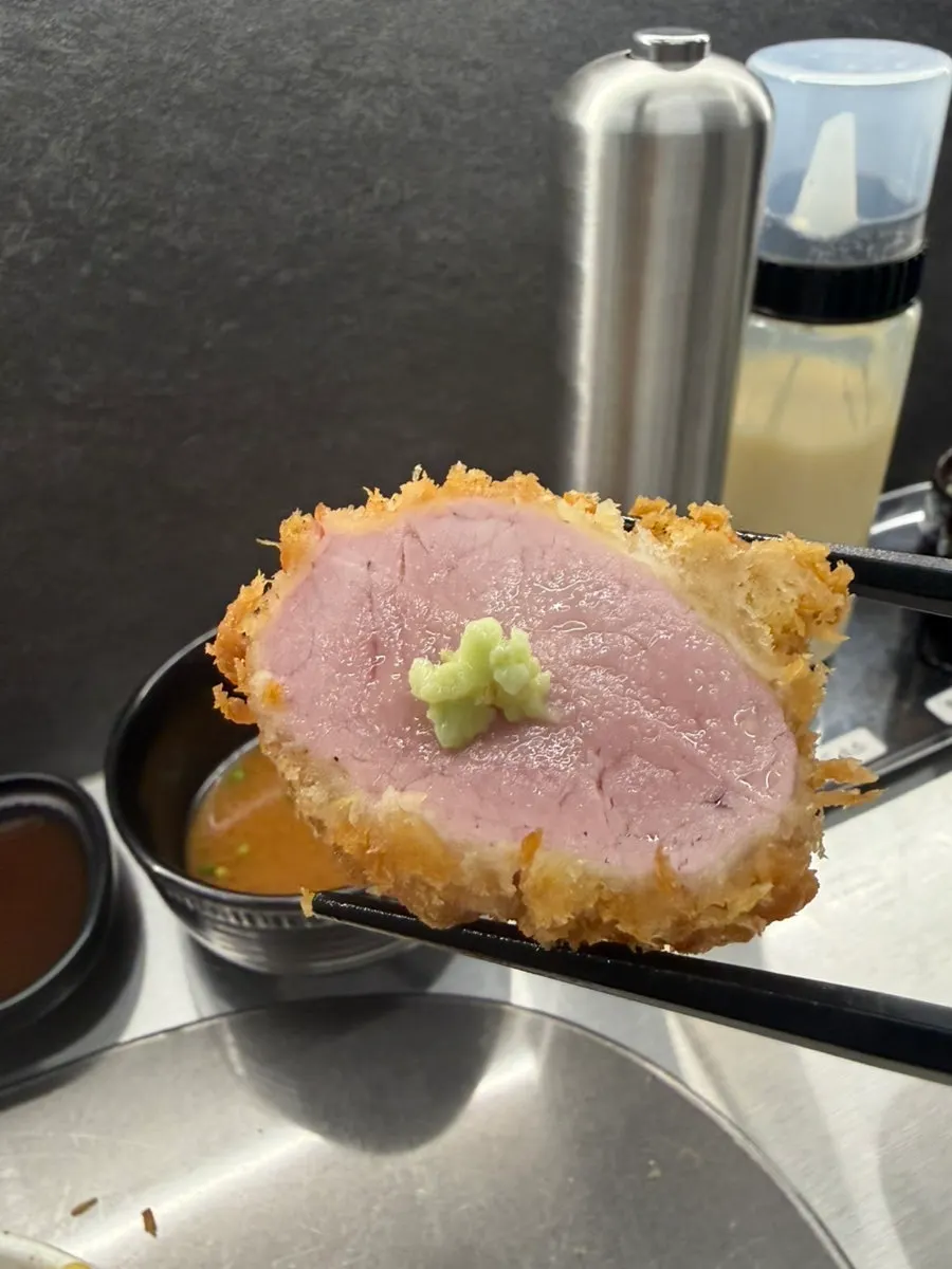 A piece of tonkatsu topped with wasabi