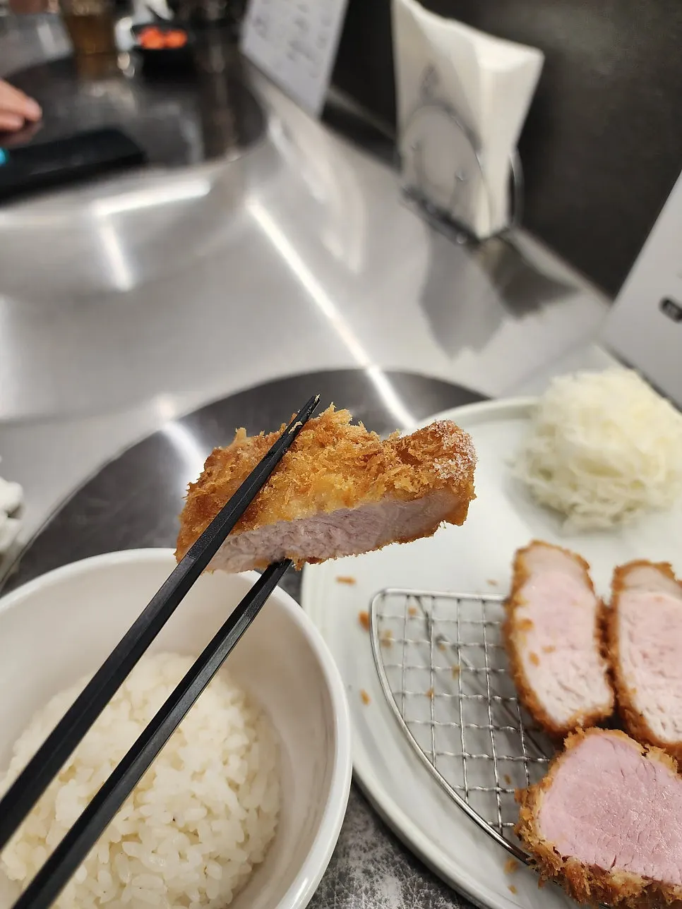 A bite of katsu served with salad