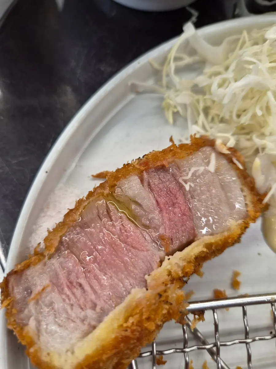 Cross-section of sang loin katsu topped with truffle oil