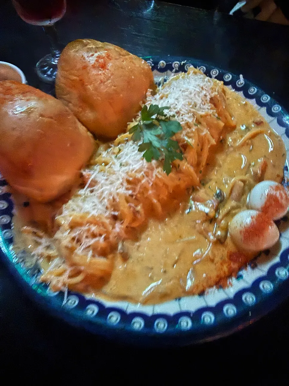 Gochujang rosé pasta topped with bread and a soft-boiled egg