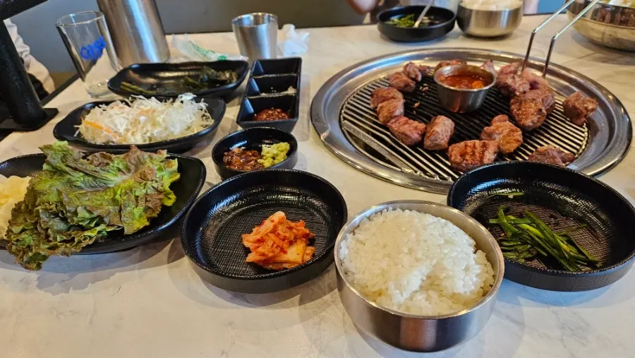 A full spread of meat served with wraps