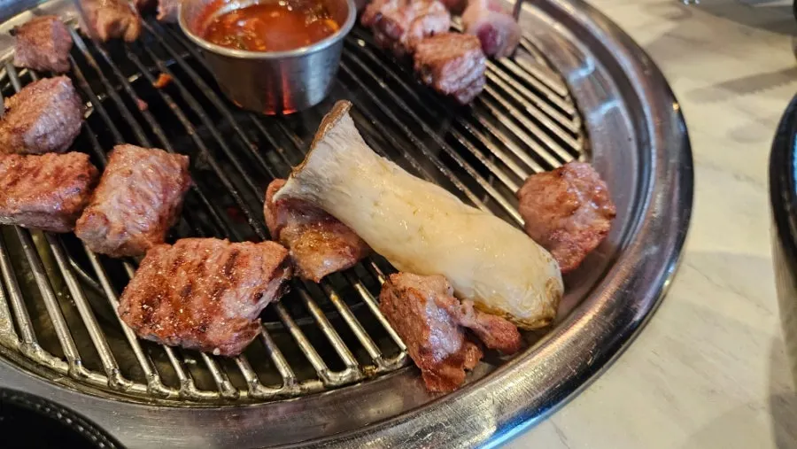 King oyster mushrooms grilled and cut by the owner