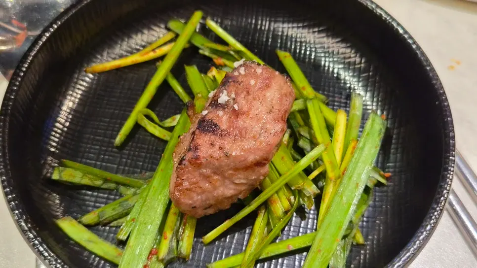 A piece of meat served with salt and ssamjang