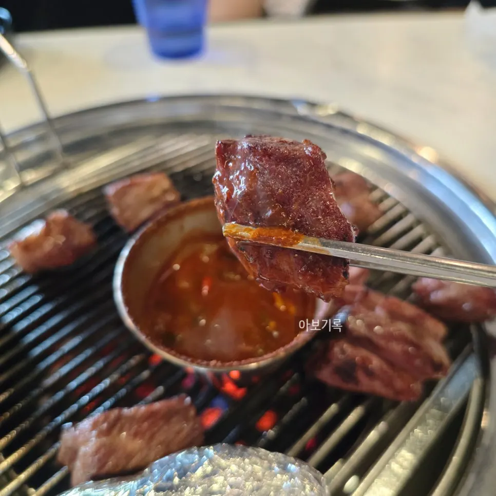 A piece of black pork neck meat dipped generously in meljeot